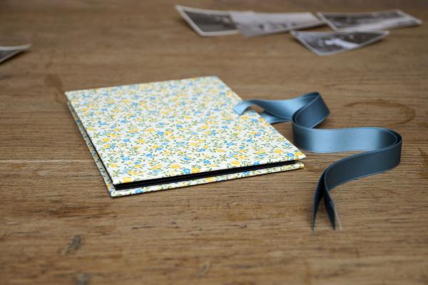Yellow mini photo album with small flowers, yellow bow